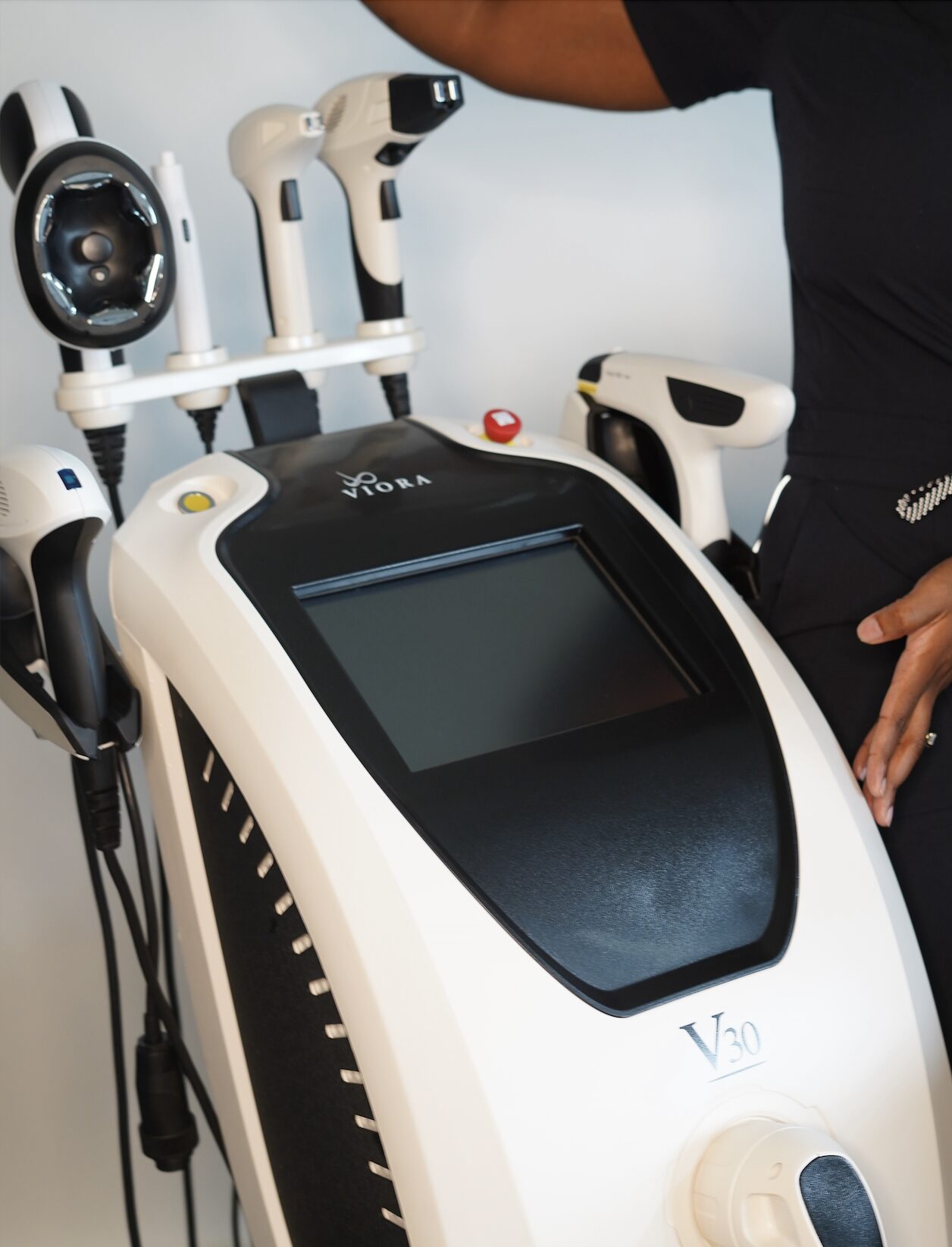 Sinclair Viora V30 1 - RejuviLux Wellness, PLLC a woman standing next to a machine